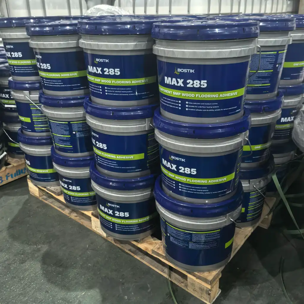 Bostik MAX285 SMP wood flooring adhesive pails stacked in warehouse ready for distribution